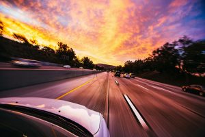 white car in motion on a scenic highway